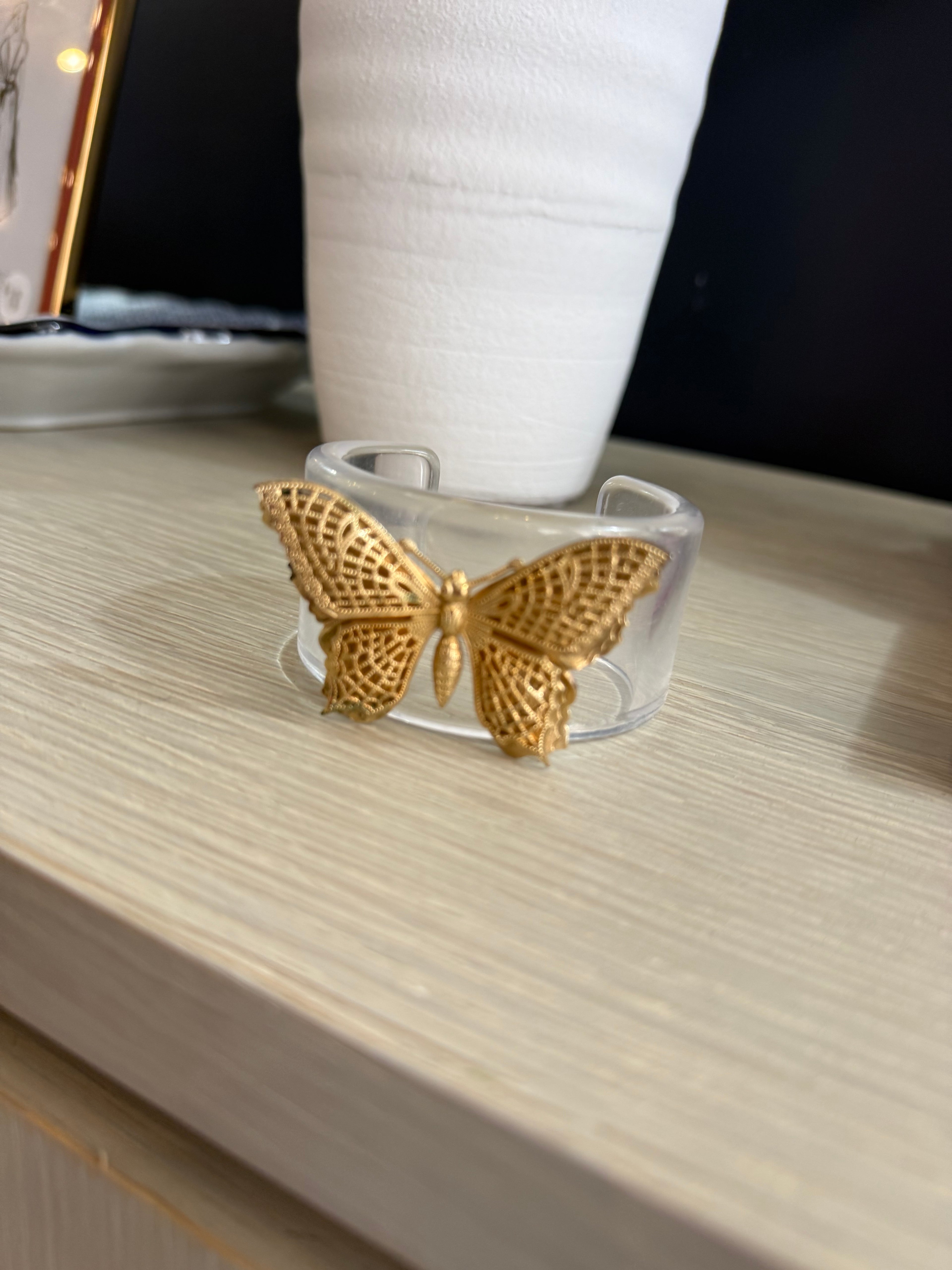 Acrylic cuff with butterfly brooch