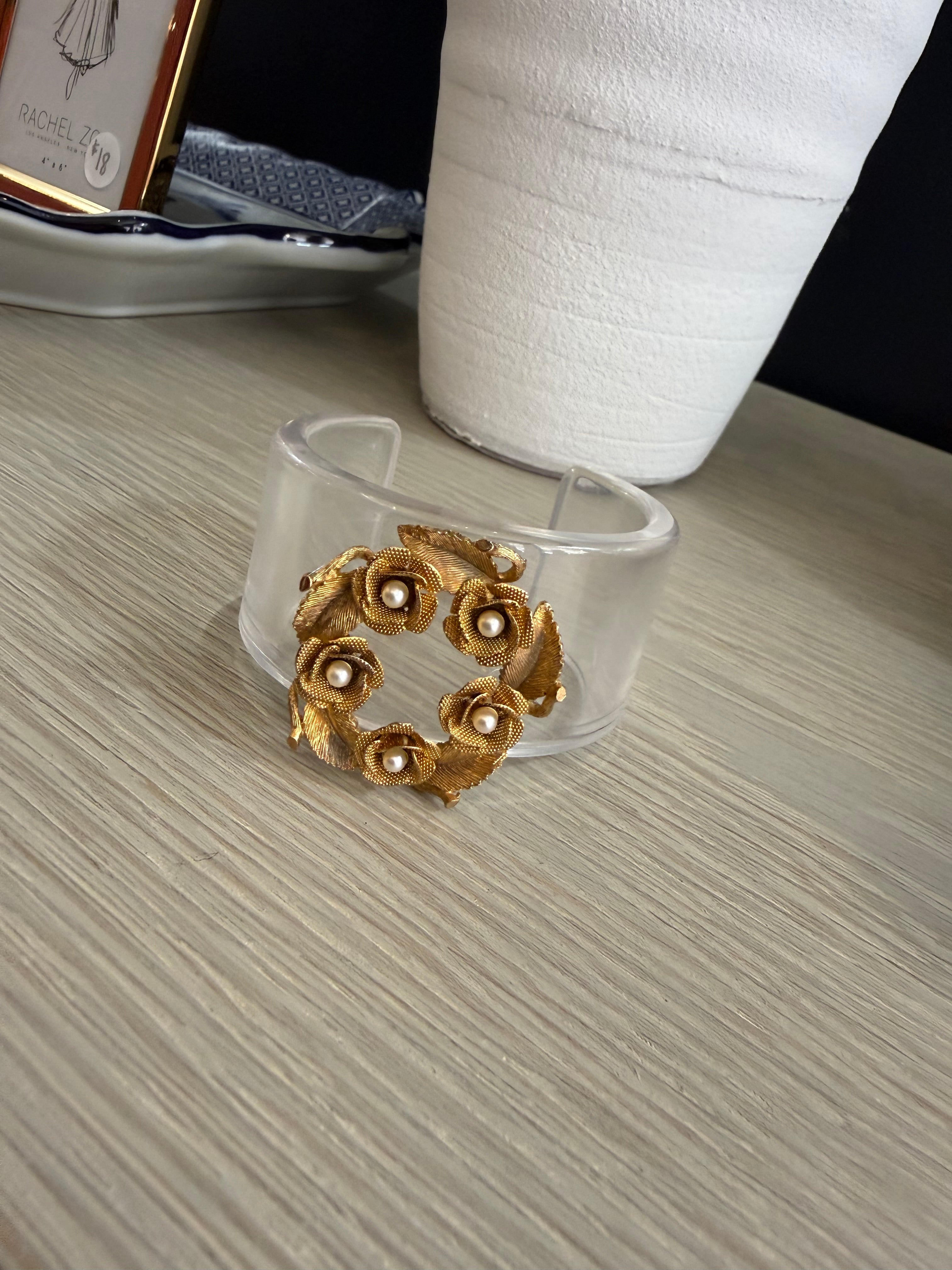 Acrylic cuff with pearl floral brooch